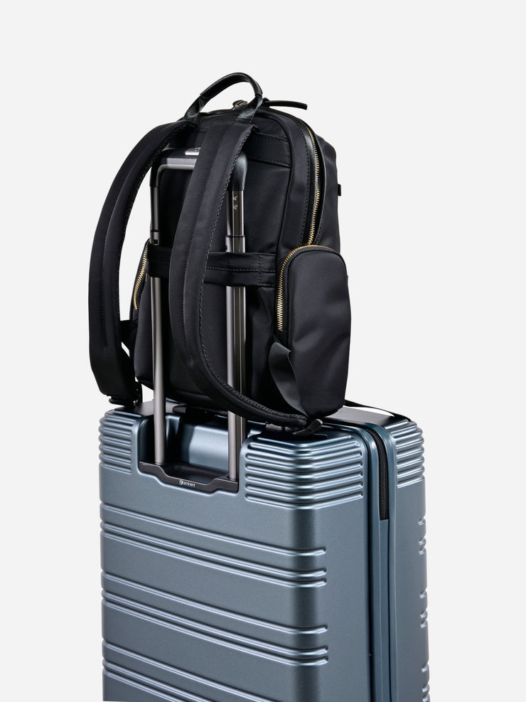 Eminent Litepak Backpack Black fixed on top of suitcase